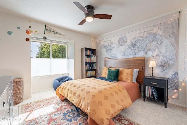 bedroom with a ceiling fan, carpet flooring, and baseboards