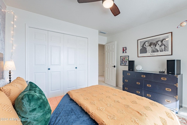 bedroom with light carpet, ceiling fan, a closet, and visible vents