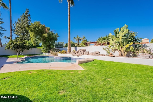 view of swimming pool featuring a lawn, a patio area, a fenced backyard, and a fenced in pool