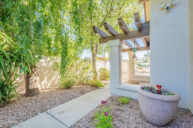 view of yard with fence and a pergola