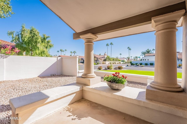 view of patio / terrace featuring a residential view, covered porch, and fence