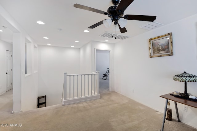 corridor featuring light colored carpet