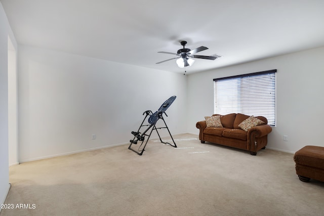 workout area with light carpet and ceiling fan