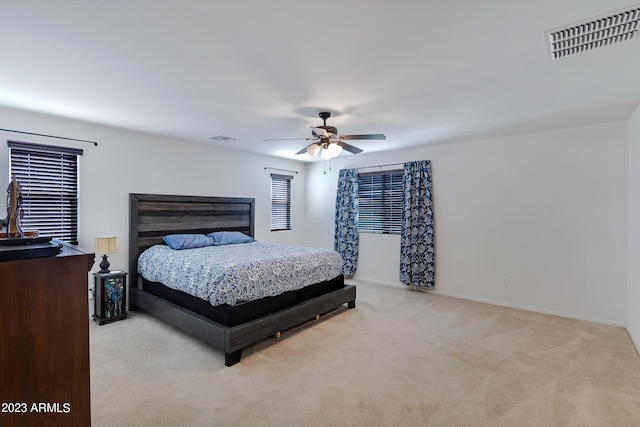 bedroom with ceiling fan and light carpet