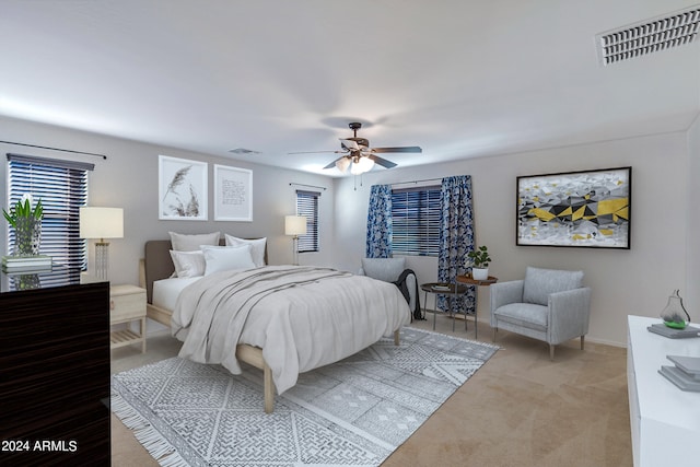 bedroom with ceiling fan and light carpet