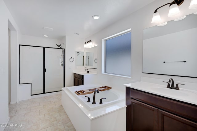 bathroom with vanity and independent shower and bath