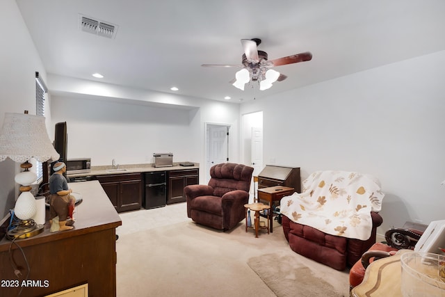 carpeted living room with ceiling fan