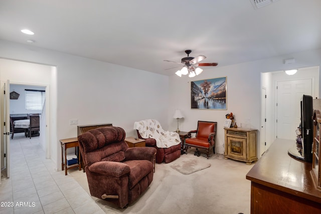 tiled living room with ceiling fan