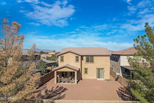 rear view of house featuring a patio