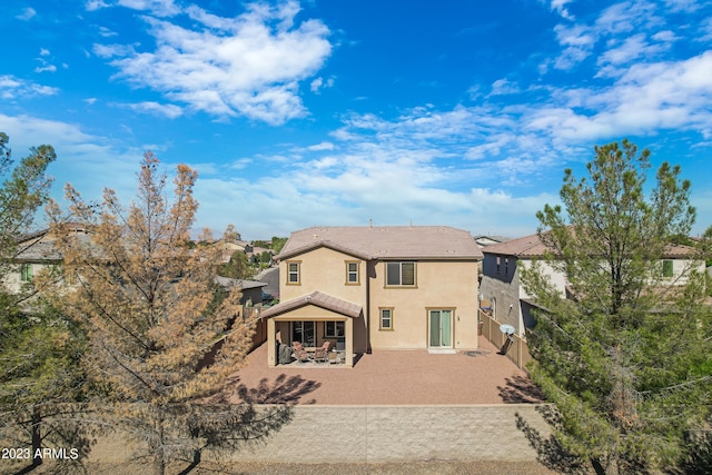 rear view of property featuring a patio area