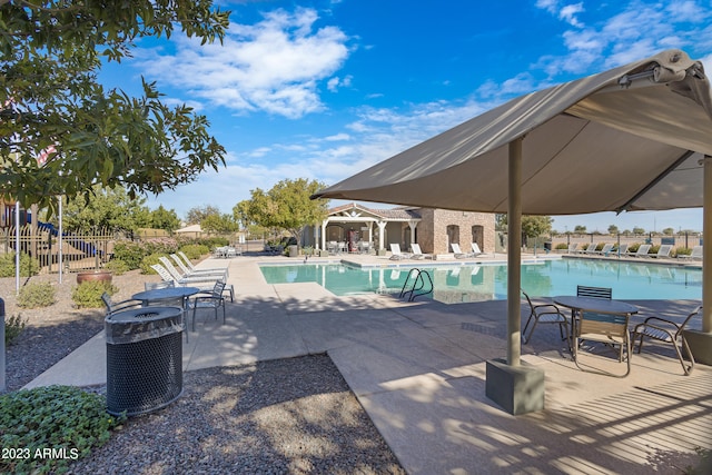 view of pool with central AC and a patio