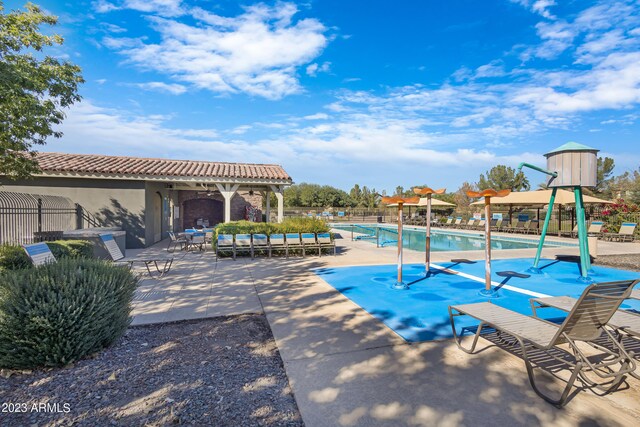 view of swimming pool featuring a patio area, ceiling fan, and an outdoor living space