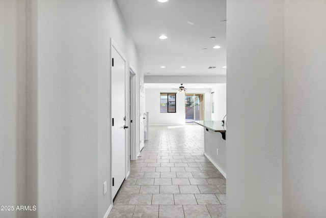 hall with light tile patterned floors