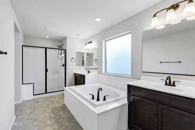 bathroom with shower with separate bathtub and vanity