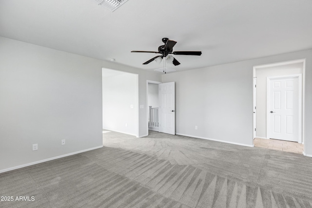 unfurnished room with ceiling fan and light carpet