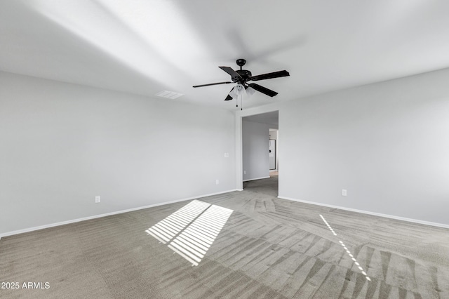 carpeted empty room featuring ceiling fan