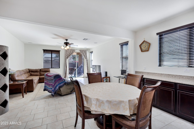 dining area featuring light tile patterned floors and ceiling fan