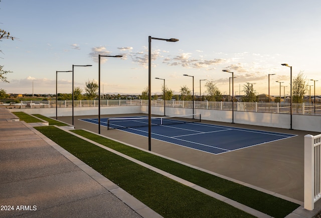 view of tennis court featuring fence