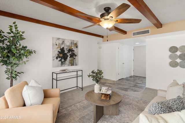 living room featuring a textured ceiling, beam ceiling, and ceiling fan