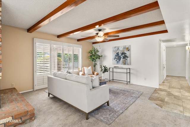 living room featuring ceiling fan, a textured ceiling, beamed ceiling, and light colored carpet