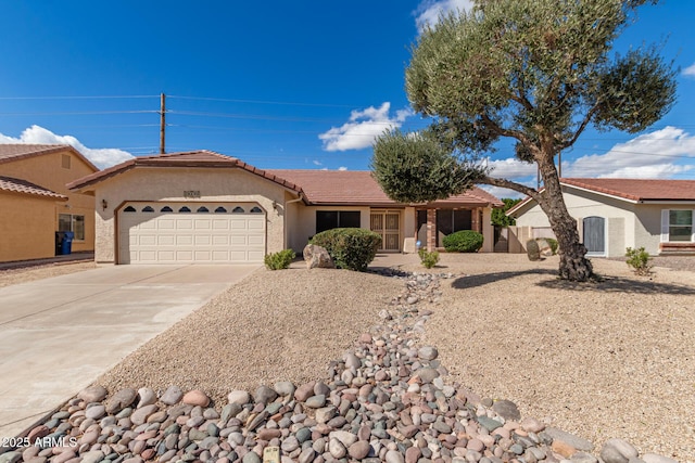 ranch-style home with driveway, an attached garage, a tile roof, and stucco siding