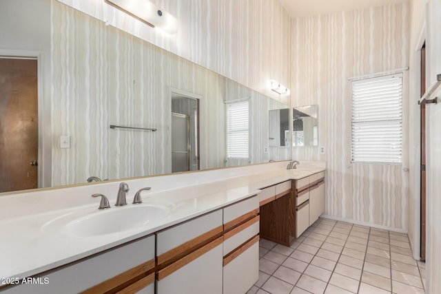 bathroom featuring tile patterned flooring, vanity, and walk in shower