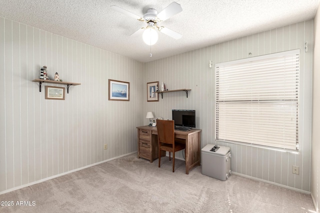 office space with carpet floors, ceiling fan, baseboards, and a textured ceiling