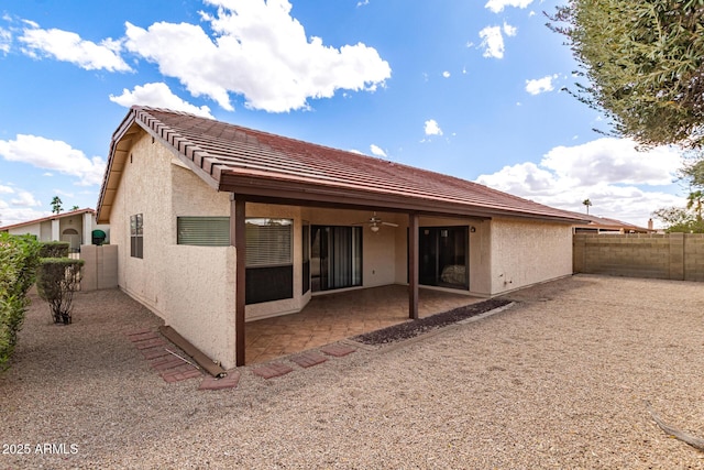 rear view of house featuring a fenced backyard, a ceiling fan, a patio, and stucco siding