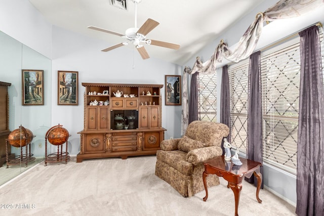 living area with visible vents, a ceiling fan, carpet flooring, vaulted ceiling, and baseboards