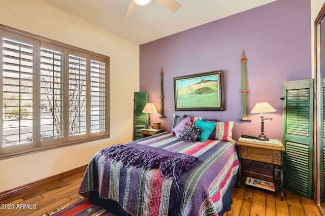 bedroom with a ceiling fan and hardwood / wood-style flooring
