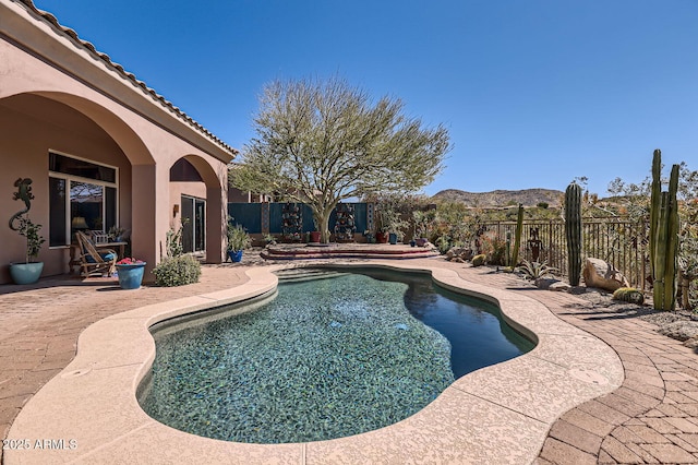 view of pool featuring a patio, a mountain view, a fenced backyard, and a fenced in pool