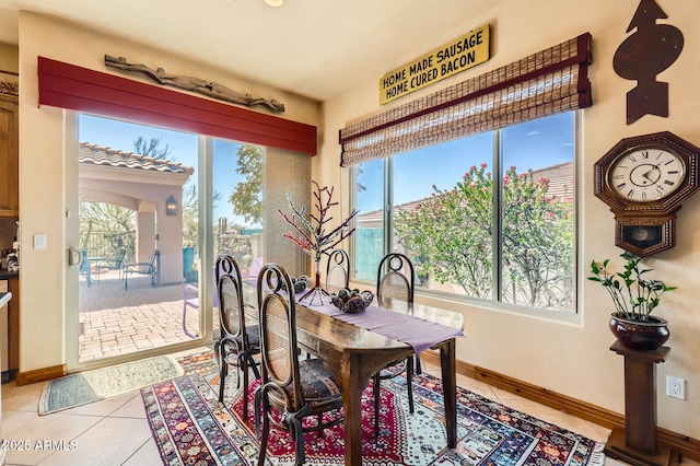 dining room with light tile patterned flooring and baseboards