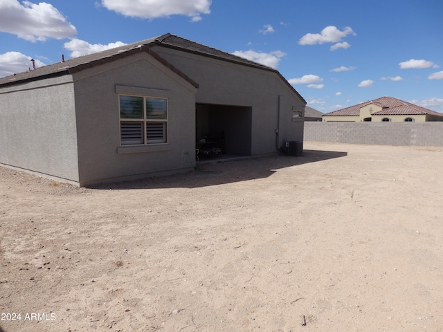 back of property featuring cooling unit