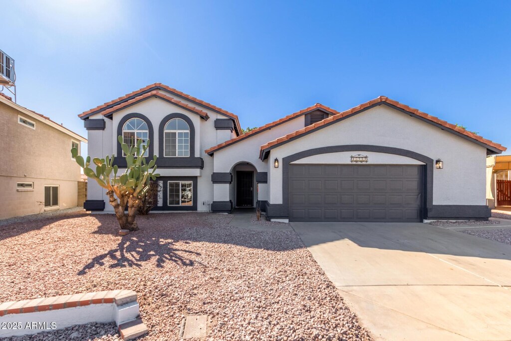 16412 S 42nd Pl, Phoenix, AZ 85048 - mediterranean / spanish home featuring an attached garage, a tile roof, concrete driveway, and stucco siding