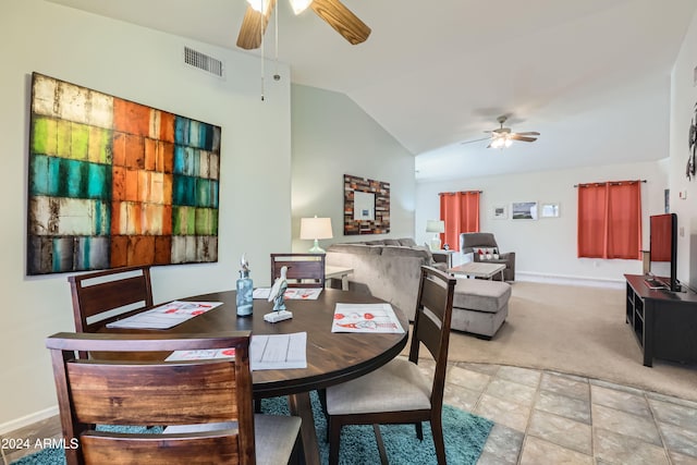 carpeted dining room featuring vaulted ceiling and ceiling fan