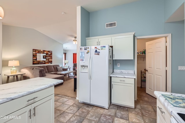 kitchen featuring vaulted ceiling, ceiling fan, white cabinets, and white appliances