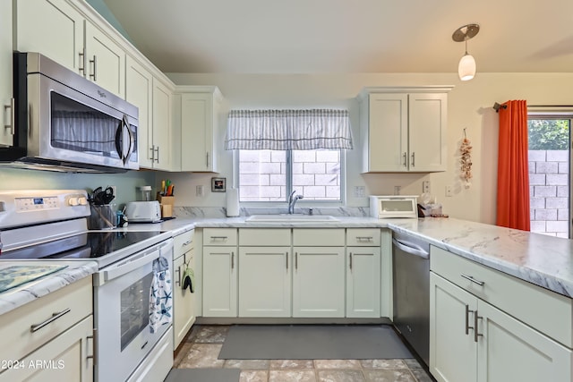 kitchen with sink, stainless steel appliances, light stone counters, decorative light fixtures, and white cabinets