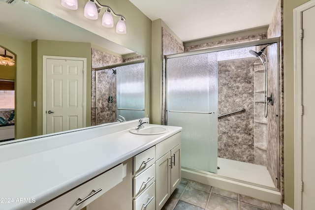 bathroom with tile patterned floors, vanity, and a shower with shower door