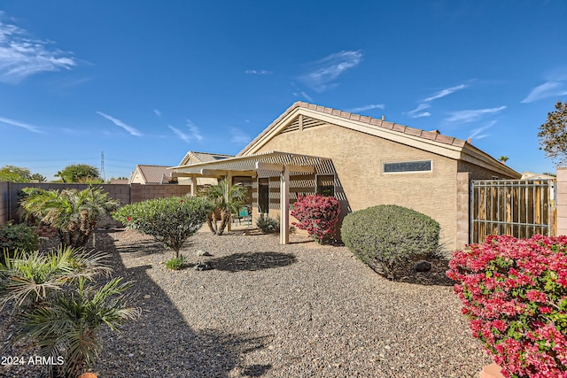 back of property featuring a pergola