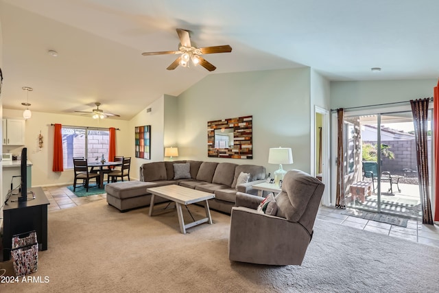 tiled living room with plenty of natural light, ceiling fan, and lofted ceiling