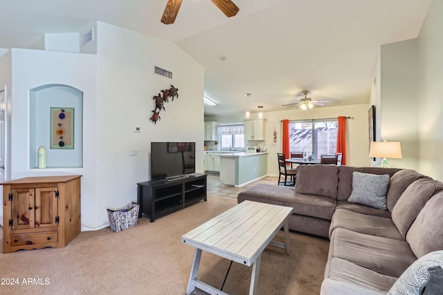 living room with ceiling fan, light colored carpet, and lofted ceiling