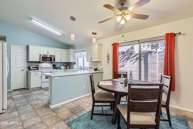 kitchen with white appliances, vaulted ceiling, ceiling fan, pendant lighting, and white cabinets