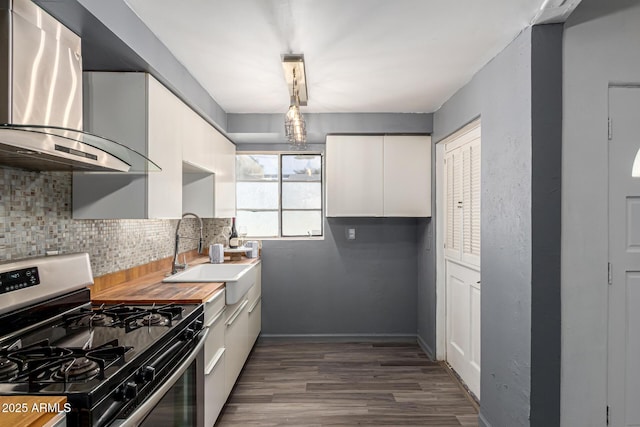 2941 N 19th Ave Unit 95, Phoenix, AZ 85015 - kitchen with stainless steel gas range, wall chimney range hood, dark wood-type flooring, and white cabinets