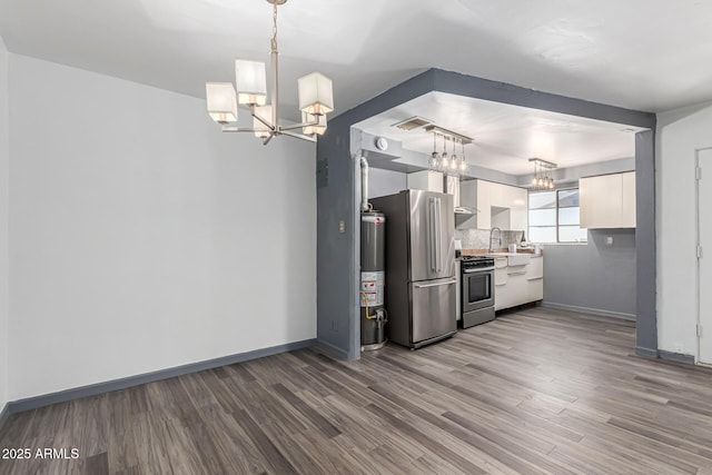 2941 N 19th Ave Unit 95, Phoenix, AZ 85015 - kitchen featuring a chandelier, appliances with stainless steel finishes, wood finished floors, and white cabinetry