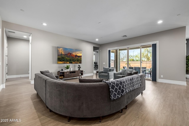 living area with recessed lighting, light wood-type flooring, baseboards, and visible vents