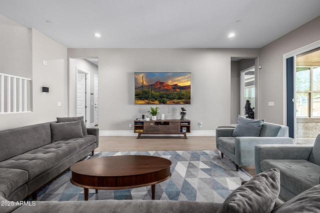 living area with recessed lighting, wood finished floors, and baseboards