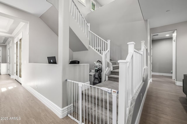 staircase with wood finished floors and baseboards