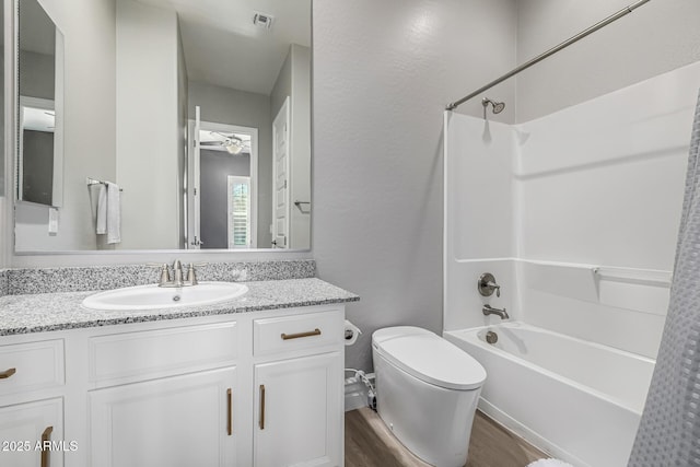 full bathroom with visible vents, toilet, bathtub / shower combination, wood finished floors, and ceiling fan