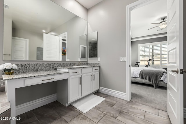 full bath with visible vents, a ceiling fan, connected bathroom, baseboards, and vanity