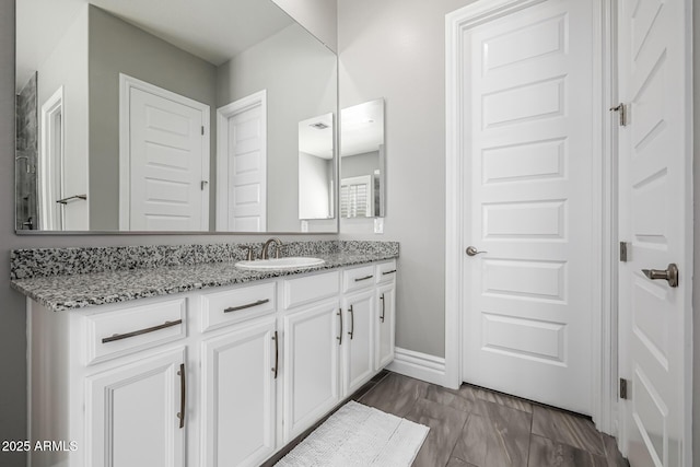 bathroom featuring baseboards and vanity